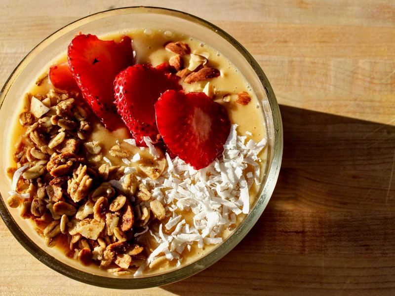 a close-up of a nutritious breakfast bowl with strawberries, granola, image