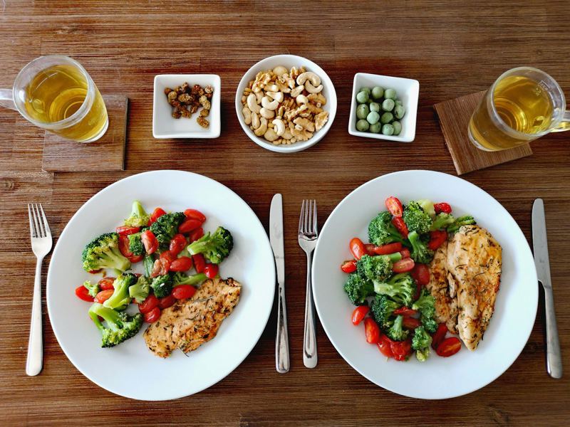 a delicious and healthy chicken dinner with fresh vegetables, nuts, an image