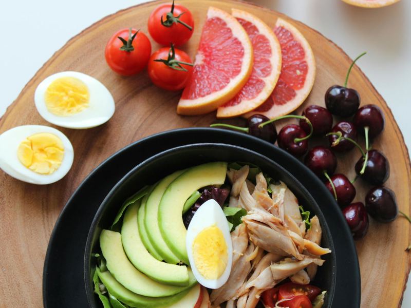 a vibrant, healthy salad bowl with avocado, eggs, tomatoes, grapefruit image