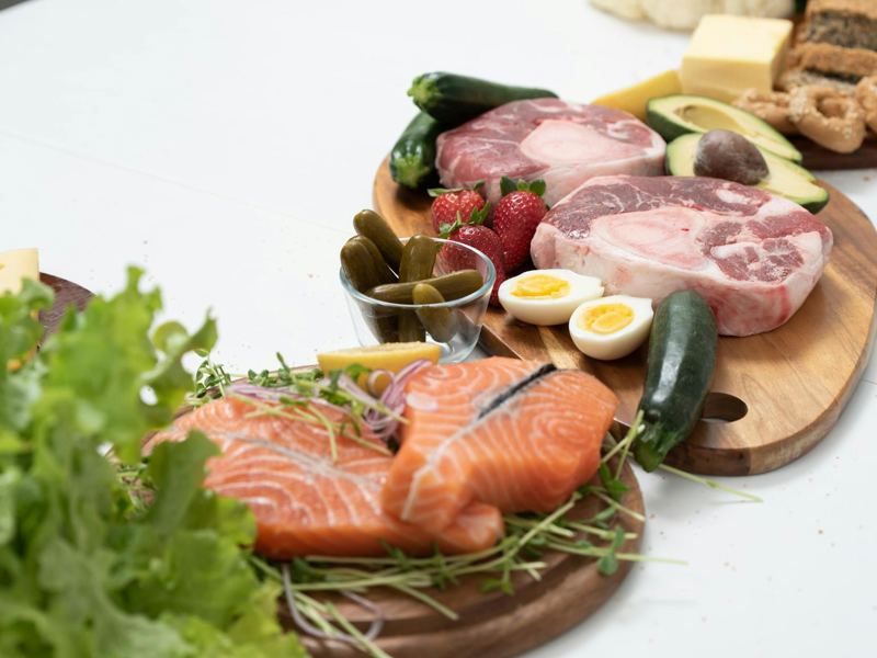 assorted fresh keto ingredients including salmon, beef, and vegetables image