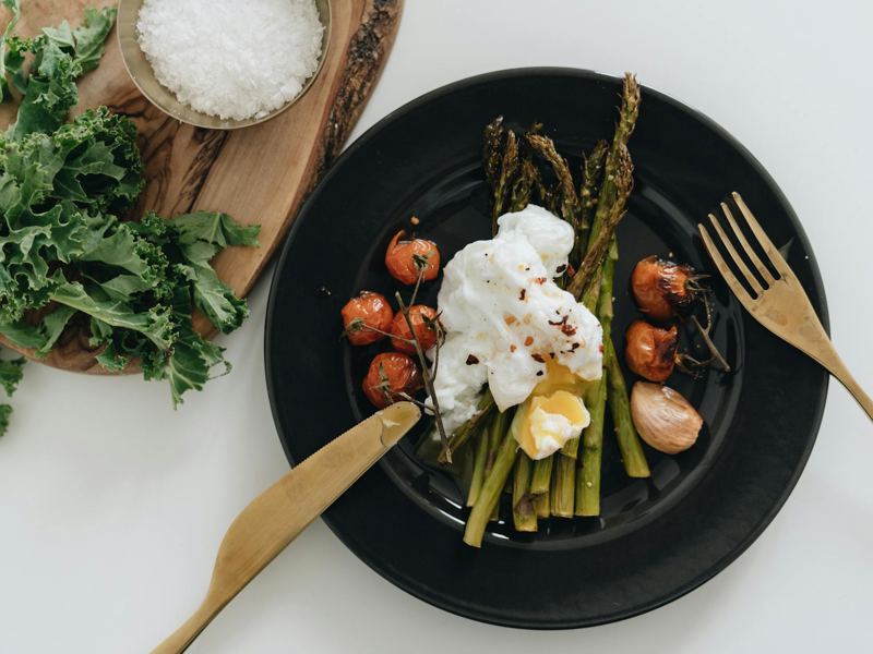 delicious poached egg on asparagus with cherry tomatoes. perfect for a image